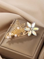 Macro detail of golden flower hair clip with sparkling crystals and elegant pearls - Marquise Flower Style