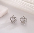 Orecchini geometrici quadrati minimalisti con zircone trasparente su sfondo in tessuto bianco - Argento