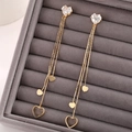 Eleganti orecchini a pendente con nappe a cuore dorate e perni in zircone a cuore - Oro