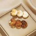 Retro acrylic heart hair clips in cream yellow and amber brown on a silk background - Multicolor