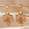 Macro shot of gold floral earrings with champagne zircons on beige silk backdrop - Gorgeous Sun Flower Radiant Style (EQ145) / Gold/Amber/Champagne