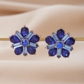 Elegant gold flower earrings with blue teardrop gemstones on champagne silk - Blue
