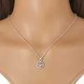 Close-up of sparkling silver cluster pendant with central diamond and halo on a mannequin - Silver Concentric Circle Cluster Style (NQ114)
