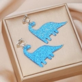 Detail of glittery blue acrylic dinosaur earrings with silver clips for children - Bright Blue Glitter Dinosaur