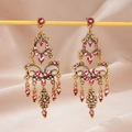 Vintage bohemian style bronze alloy earrings with red crystals and tassels - Purple