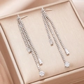 Macro detail of elegant silver tassel earrings with zircon stones on champagne silk - Silver Long Multi-layer Rhinestone Tassel Style (EQ250)
