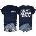 Detail view of double-sided 'In My Memaw Era' print on navy t-shirt with denim shorts - Navy Blue (White Graphic)