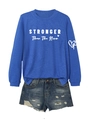 Detail of royal blue crewneck sweatshirt with STRONGER text and distressed denim shorts - S / Vintage Blue