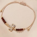 Detailed shot of beige woven dragonfly bracelet with crystals and evil eye charm - Dragonfly (Rhinestone Dragonfly Pendant)