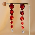 Detail of gold drop earrings with red pear-cut crystals on warm silk background - Red Waterdrop