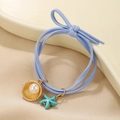 Coletero azul estilo océano con concha de perla y estrella de mar en bandeja cerámica - Estrella de Mar