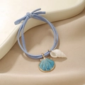 Macro shot of blue ocean style elastic hair tie with seashell and conch charms - Conch & Shell