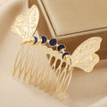 Close-up of golden butterfly wing hair comb with blue moon phase enamel and 10-tooth design - Gold