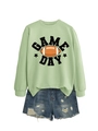 Close-up of Game Day graphic on mint green crewneck sweatshirt with denim shorts - Olive Green (Black Print)