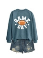 Flat lay detail of blue Game Day sweatshirt with distressed denim shorts on white background - Blue (White Graphic)