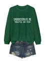 Flat lay of green crewneck sweatshirt with slogan and distressed denim shorts - Vintage Green