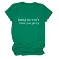 Close-up of green cotton T-shirt with 'hating me won't make you pretty' slogan print - Dark Green (White Font)