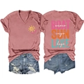 Flat lay of pink V-neck t-shirt with boat sun lake prints and ripped denim shorts - Rose Gold (White Print)