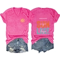 Flat lay of rose pink V-neck T-shirt with lake lettering and distressed denim shorts - Rose Red