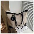 Détail du sac cabas en toile avec anses en cuir contrastées et un petit charme en peluche - Khaki Avec Pendentif