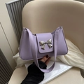 Minimalist lavender shoulder bag with silver bow buckle on elegant white silk setting - Purple