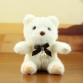 White plush teddy bear charm with brown satin bow and pearl accents for bags - White