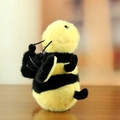 Plush bumblebee insect keychain with yellow and black fur, dangling on a wooden table - Bee / Approx. 12cm / Yellow And Black Bee