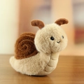 Beige and brown plush snail toy with soft texture and spiral shell detail on wood surface - Snail / Approx. 12cm / Beige Brown Snail