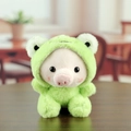 Cute pink pig plush keychain wearing a green frog hoodie on a dark wood background - Green (Frog Style) / 10cm