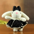 White plush bunny keychain with black bow and pearl-trimmed dress on wooden surface - Black Style