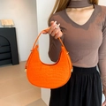 Bright orange crescent shoulder bag featuring crocodile pattern embossing and gold hardware - Orange