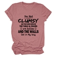 Detail of dust pink round neck T-shirt featuring bold I'M NOT CLUMSY black slogan print - S / Tops / Rose Gold