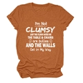 Detail of burnt orange crew neck T-shirt featuring I'M NOT CLUMSY JUST white slogan print - S / Tops / Burnt Orange (White Font)