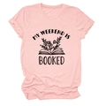 Close-up of pink round neck t-shirt with My Weekend is Booked text and flower book graphic - Pink (Black Letters)