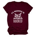 Detail of burgundy T-shirt showing printed book and My Weekend Is Booked graphic - Wine Red (White Letters)