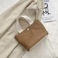 Brown woven straw tote bag with beige handles and decorative button closure - White