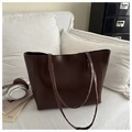 Detail of a large dark brown tote bag on a white sofa with headphones and a magazine - Dark Brown