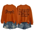 Detail view of orange cotton sweatshirt featuring artistic printed slogan on front and back - S / Burnt Orange (Black Font)