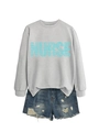 Detail of grey sweatshirt showing nurse letter print with healthcare words on soft fabric - Gray