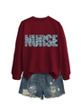 Detail of burgundy crewneck sweatshirt with turquoise NURSE typography and denim shorts - Burgundy