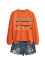 Detail of orange sweatshirt with Be Kind lettering and distressed denim shorts layout - Orange (Black Print)
