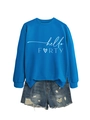Detail of hello FORTY printed blue sweatshirt paired with distressed denim shorts - Lake Blue (White Font)