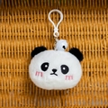Close-up of plush panda keychain with embroidery details, white bell, and plastic hook - Black & White
