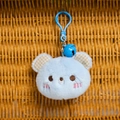 Detail of light blue plush bear keychain with plaid inner ears and blue metal bell - Blue