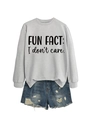 Detail of grey crewneck sweatshirt with 'FUN FACT' print and distressed denim shorts - Grey Sweatshirt (Black Font)