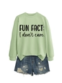 Flat lay of light green crewneck sweatshirt with Fun Fact print and denim shorts - Olive Green Sweatshirt (Black Font)