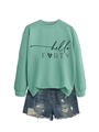 Detailed view of mint green hello FORTY sweatshirt paired with distressed denim shorts - Light Green (Black Font)