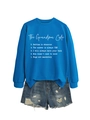 Close-up of The Grandma Code blue sweatshirt paired with ripped denim shorts details - Lake Blue Sweatshirt (White Font)