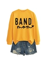 Close-up of ginger yellow sweatshirt with BAND mom print and frayed denim shorts - Yellow (Black Font)
