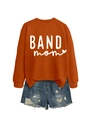 Flat lay of rust red sweatshirt with BAND mom text and distressed blue denim shorts - Burnt Orange (White Font)